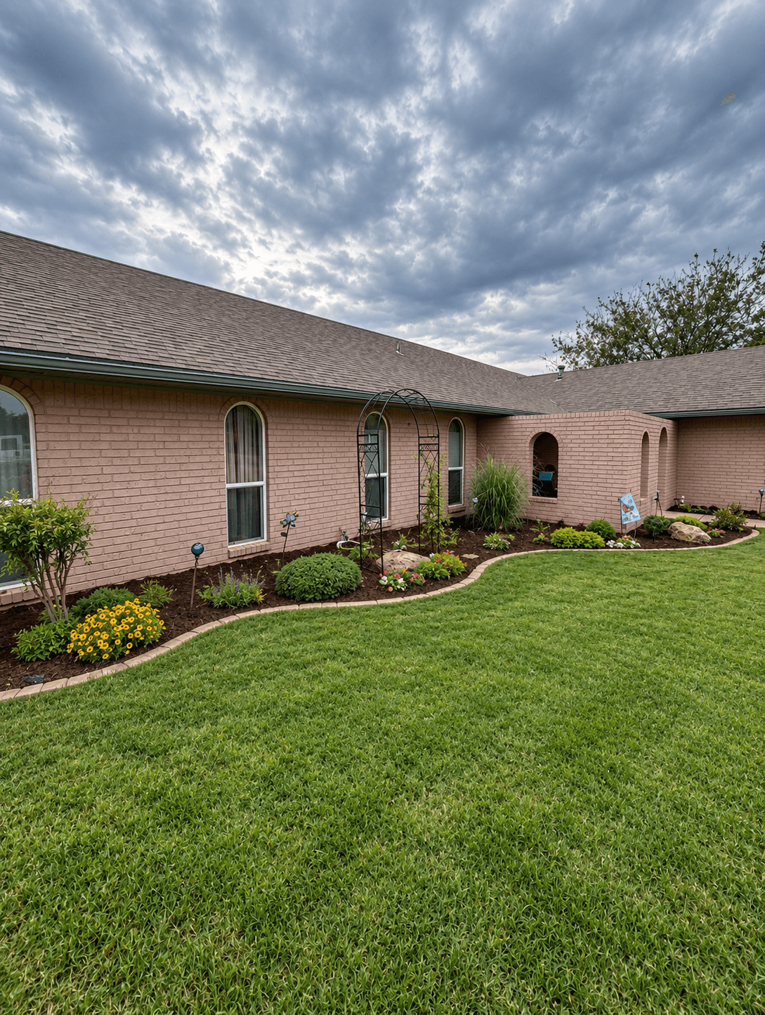 Wide landscape bed wrapping a residential home